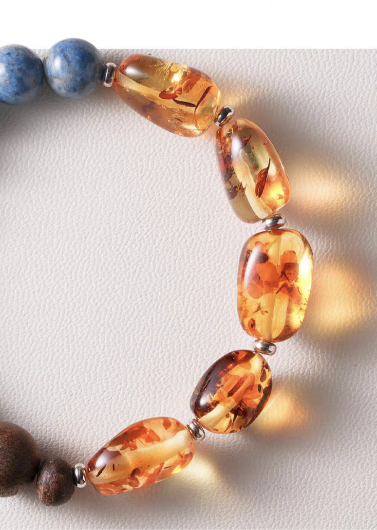 Handmade Blue Crystal, Amber, and Wood Bracelet displayed on a wooden surface – A natural, handcrafted jewelry piece for spiritual balance.