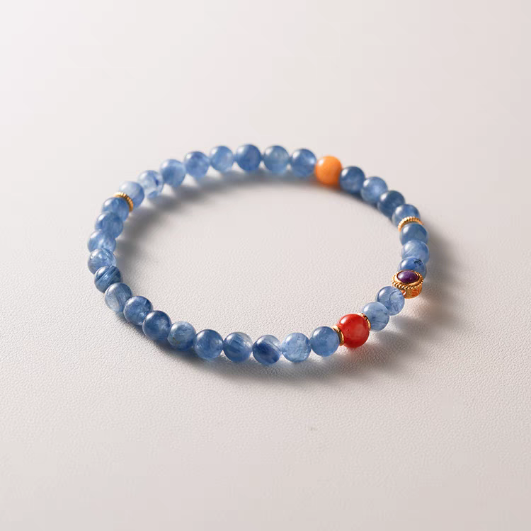 Nirvana Lumière Handmade Blue Crystal and Orange Jade Bracelet worn on wrist – A healing bracelet to enhance clarity, emotional balance, and positive energy.