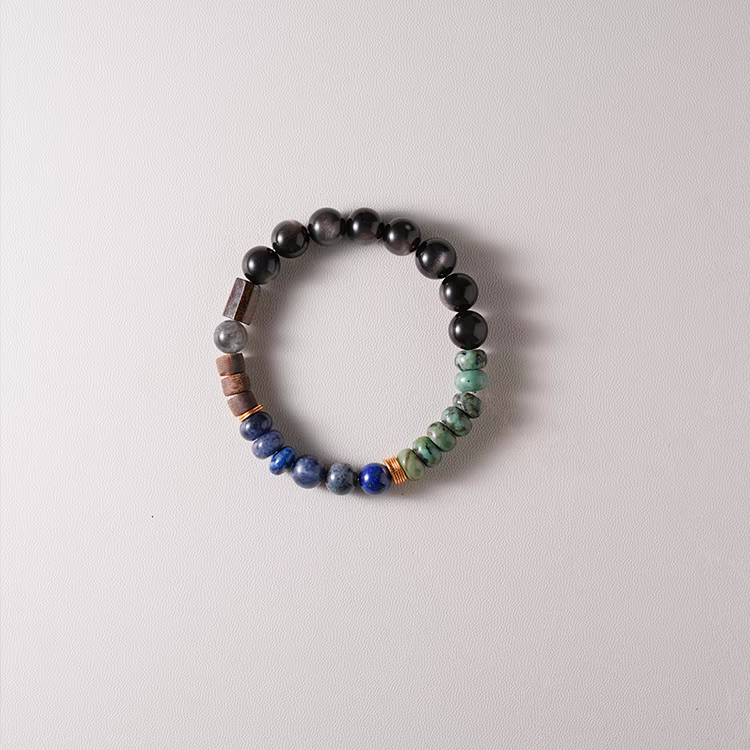 Handmade Earth & Sky Energy Bracelet worn on wrist – Combining Lapis Lazuli, Green Jasper, Black Onyx, and Gold for emotional balance and grounding.