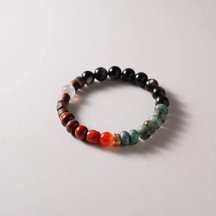 Nirvana Lumière Handmade Earth Energy Bracelet worn on wrist – A stylish and healing accessory combining Black Agate, Green Jasper, and Orange Carnelian.