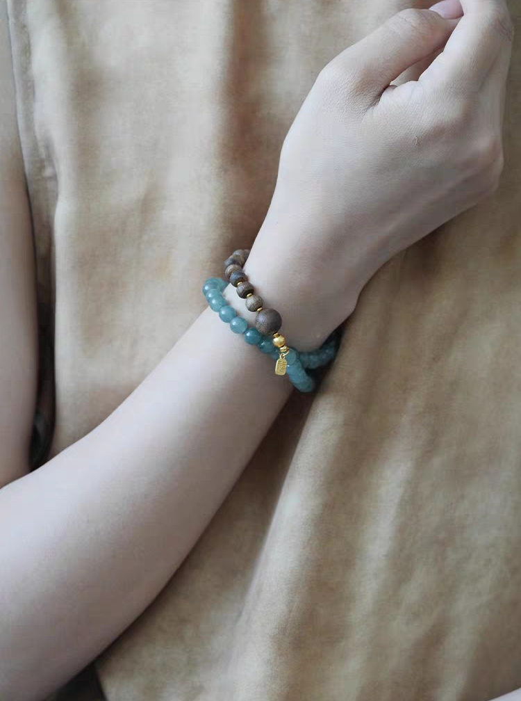 Model wearing Healing Green Aventurine Wood Bracelet – A stylish gemstone bracelet designed to promote peace and clarity.