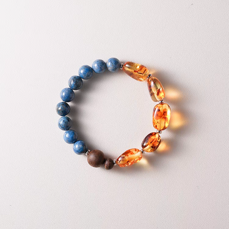 Handmade Blue Crystal, Amber, and Wood Bracelet in eco-friendly packaging – Perfect as a gift for wellness and healing.