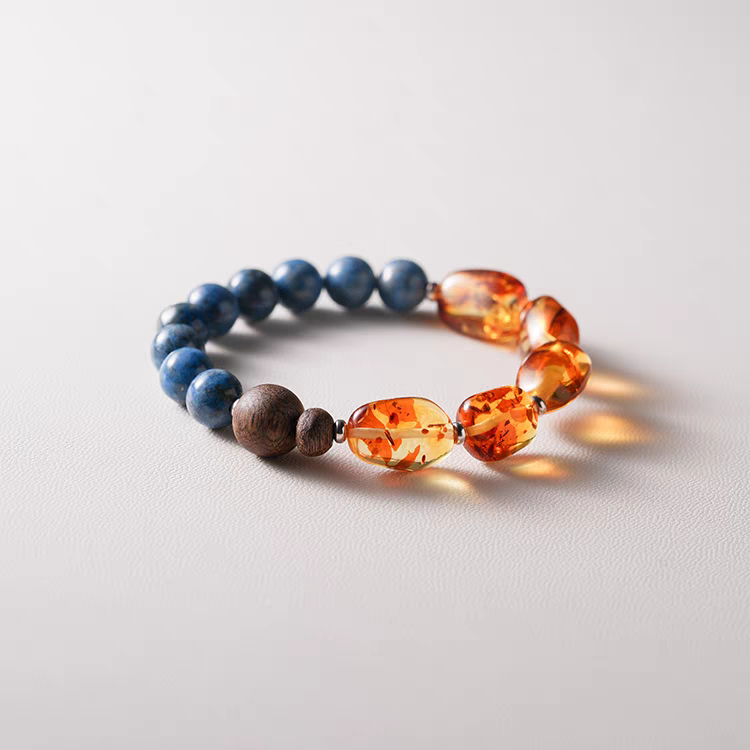 Model wearing a Handmade Blue Crystal, Amber, and Wood Bracelet – A healing bracelet designed for positive energy and emotional wellness.