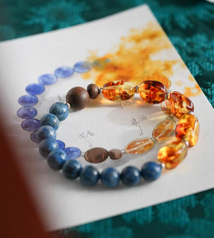 Handmade Blue Crystal, Amber, and Wood Bracelet displayed on a wooden surface – A natural, handcrafted jewelry piece for spiritual balance.