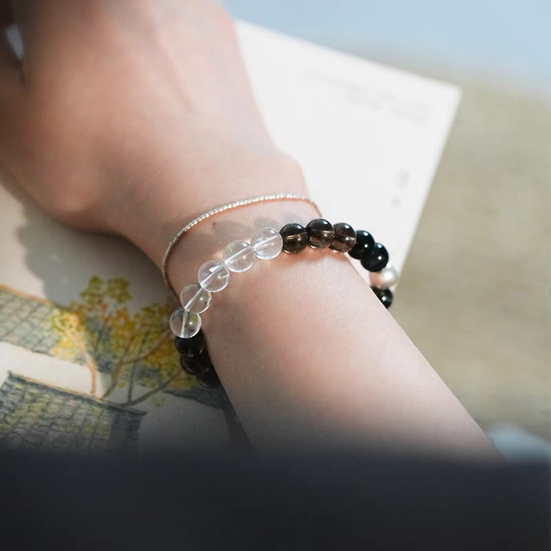 Close-up of Black Tiger Eye beads in healing bracelet, known for enhancing focus and protection