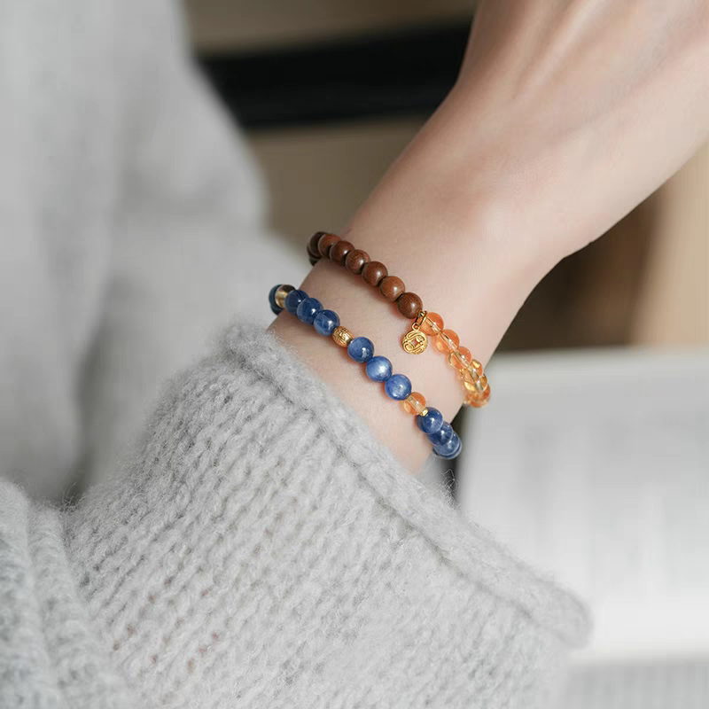 Close-up of natural amber and crystal beads on a handcrafted healing bracelet designed for emotional balance and clarity.