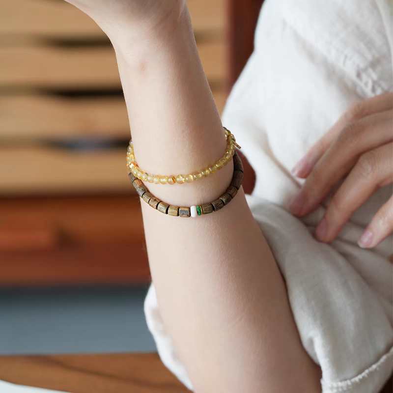 Qiū Shí Xù Feng Shui Bracelet being cleansed with Palo Santo smoke, enhancing its energetic properties