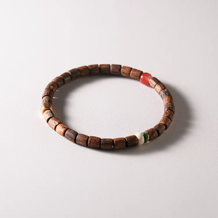 Close-up of fossilized mammoth ivory beads in Qiū Shí Xù Feng Shui Bracelet, symbolizing ancestral wisdom