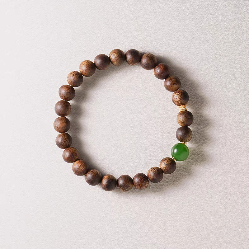 Close-up of Qingyan bracelet featuring jade and wooden beads, symbolizing balance and grounding energy.