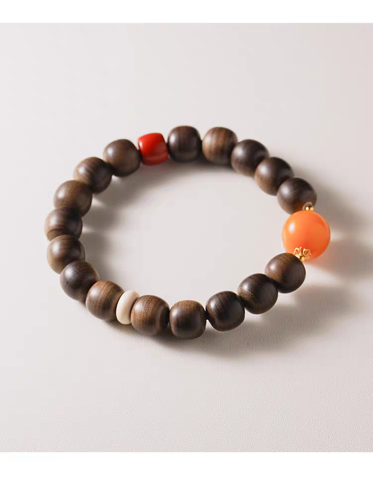 Chanyin handmade natural gemstone healing bracelet featuring black obsidian and carnelian beads on wrist with 18k gold accents.