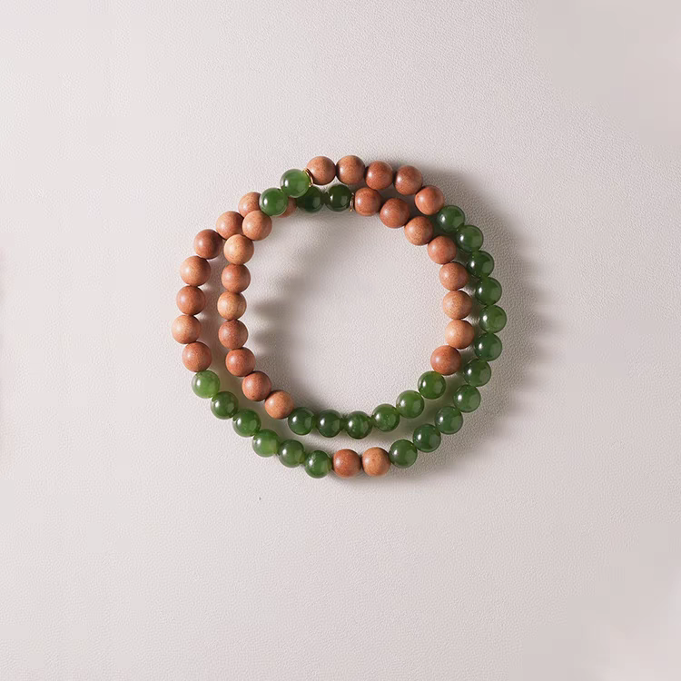 Worn Luoyan natural stone bracelet showcasing its elegant design with green jade and sandalwood